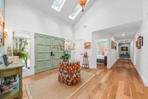 a living room with a green door and a table at 2565 The Haul Over in Seabrook Island +35 photos