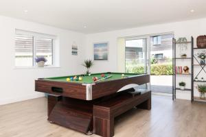 a living room with a pool table in it at Sandy Cove in Penzance