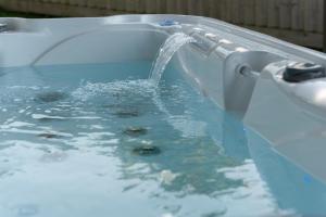 a bath tub with water pouring out of it at Sandy Cove in Penzance