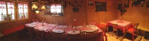 a dining room with a table with a red table cloth at kleines Doppelzimmer mit Dusche WC in Muotathal