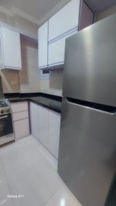 a kitchen with white cabinets and a stainless steel refrigerator at Eamar tower 2 in Tanta