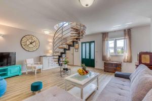 a living room with a spiral staircase and a table at Holiday home in Hreljin 39447 in Hreljin