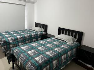 two beds sitting next to each other in a bedroom at Departamento en Residencial in Mexico City