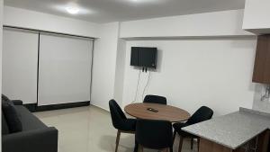 a room with a table and chairs and a couch at Departamento en Residencial in Mexico City