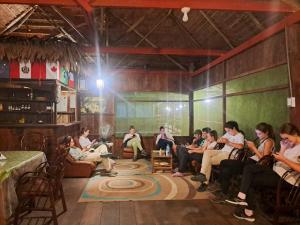 a group of people sitting in a room at Jacamar Lodge Expeditions in Iquitos