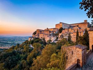 a town on a mountain at sunset at Lemon Tree Boutique Guest House in Todi