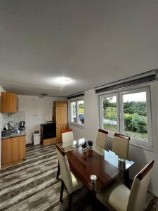 a kitchen and dining room with a table and chairs at Villa Melek in Bihać