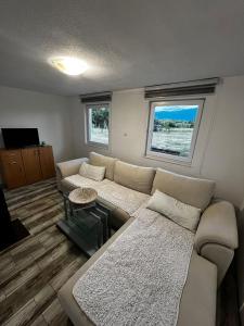 a living room with a couch and a table at Villa Melek in Bihać