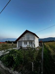 a white house in the middle of a field at Villa Melek in Bihać