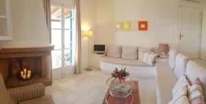 a living room with a couch and a fireplace at Naxos Beachvilla in Plaka