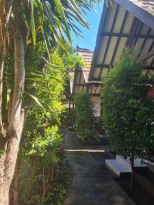 a courtyard of a house with trees and plants at Puring Bungalows Gili Air in Gili Air