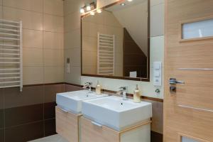 a bathroom with a white sink and a mirror at Apartament Przyjemna Opole in Opole +9 photos
