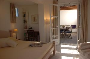 a bedroom with a bed and a dining room at Naxos Beachvilla in Plaka