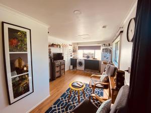 ロトルアにあるAdorable Self Contained One Bedroom Studioのソファとテーブルのあるリビングルーム