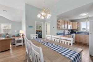 a dining room and kitchen with a table and chairs at Dream23 in Corolla