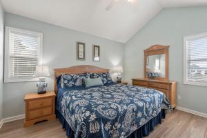 a bedroom with a bed and two night stands at Dream23 in Corolla