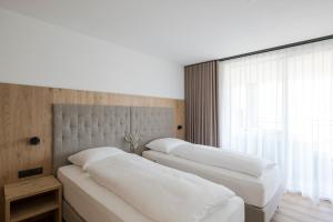 3 posti letto in una camera con finestra di Ramilia Family Apartments Restaurant & Pizzeria a Naturno Altre 36 foto