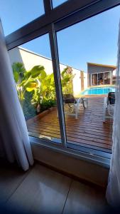 a view of a deck from the window of a room at Vivenda Bela Vista, Casa aconchegante na Capital do Paraquedismo e Balonismo in Boituva