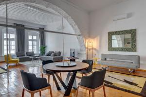 a living room with a table and chairs at Kois Loft in Ermoupoli