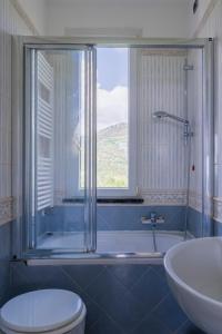 a bathroom with a toilet and a sink and a window at Sweet Helen with Sea View in Levanto +33 photos