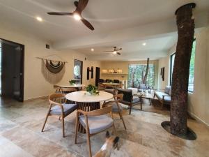 a living room with a table and chairs at Villa with a private pool in Tulum