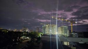 a city skyline at night with a building under construction at Bright & Airy 2BR in CBD Harare Modern with city view in Harare