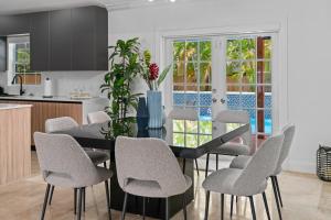 a kitchen and dining room with a table and chairs at Miami house Heated Pool Game Room BBQ L67 in Lindgren Acres
