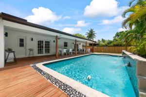 a swimming pool in the backyard of a house at Miami house Heated Pool Game Room BBQ L67 in Lindgren Acres