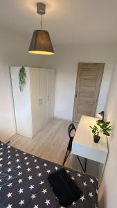 a room with a bed and a desk and a table at Rooms in Warsaw - G9 in Warsaw +19 photos