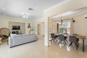 a living room with a couch and a table and chairs at NEW 3BR 2BA Private Villa with Spacious Garden in Noord