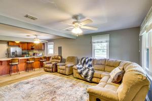a living room with a couch and chairs and a kitchen at 2 Mi to Shops and Eats Family Home in Donalsonville in Donalsonville