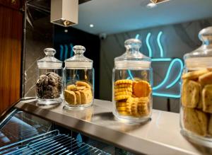 three glass containers filled with different types of pastries at The Prime Delhi in New Delhi