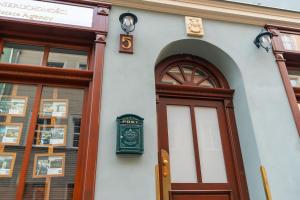 a building with a door and a clock on it at Old House Apartments 2 Poznań in Poznań