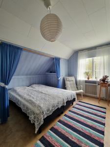 a bedroom with a bed and a rug at Huset Solhem in Resta