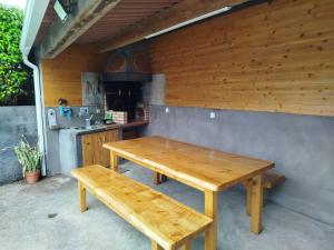 a wooden table and benches in a kitchen at Beleza da Fazenda in Nordeste +10 photos