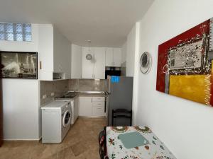 a small kitchen with a sink and a refrigerator at Apartament 1+1 Golem in Golem