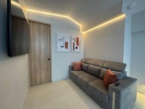 a living room with a couch and a door at 5BR Poblado House to close LlerasPark Jacuzzi AC in Medellín