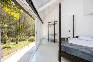 a bedroom with a bed and a large window at CH105 Poblado 7BR Villa Jacuzzi AC 24 hours Security in Medellín +120 photos