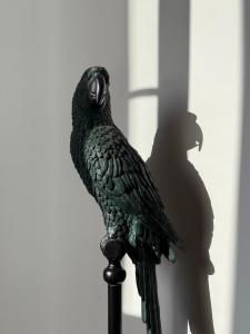 a statue of a bird sitting on a pole at Galeria 99 in Porto +9 photos