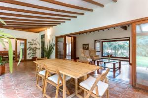 a dining room with a wooden table and chairs at CH51 Colonial Charm Villa at El Poblado Jacuzzi in Medellín