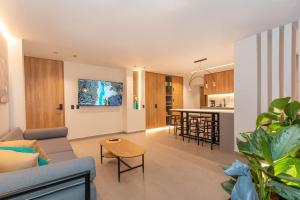 a living room and kitchen with a couch and a table at Luxury Poblado House 12 Rooms 2 Jacuzzis AC in Medellín