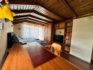 a living room with a large wooden table in a room at Къща за гости Заркови in Gaber