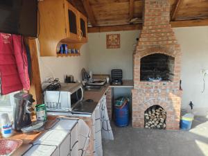 a kitchen with a brick oven and a stove at Complex CRAI Varciorog in Vîrciorog