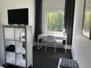 TV/trung tâm giải trí tại Rentalux Hostel - Modern Comfort, Single Rooms
