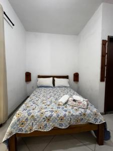 a bedroom with a bed with two phones on it at Toca Da Onça Suítes in Lençóis +30 photos