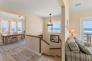 a living room with a couch and a table at Everlasting Moon in Rodanthe