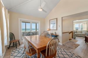 a dining room with a table and chairs at Everlasting Moon in Rodanthe