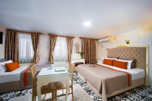 Postel nebo postele na pokoji v ubytování Alhambra Apart Hotel