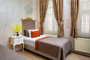 Postel nebo postele na pokoji v ubytování Alhambra Apart Hotel