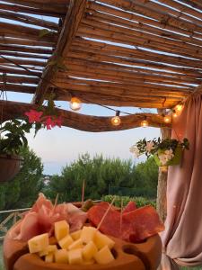 a plate of cheese and fruit on a table at La Trave in Montecosaro